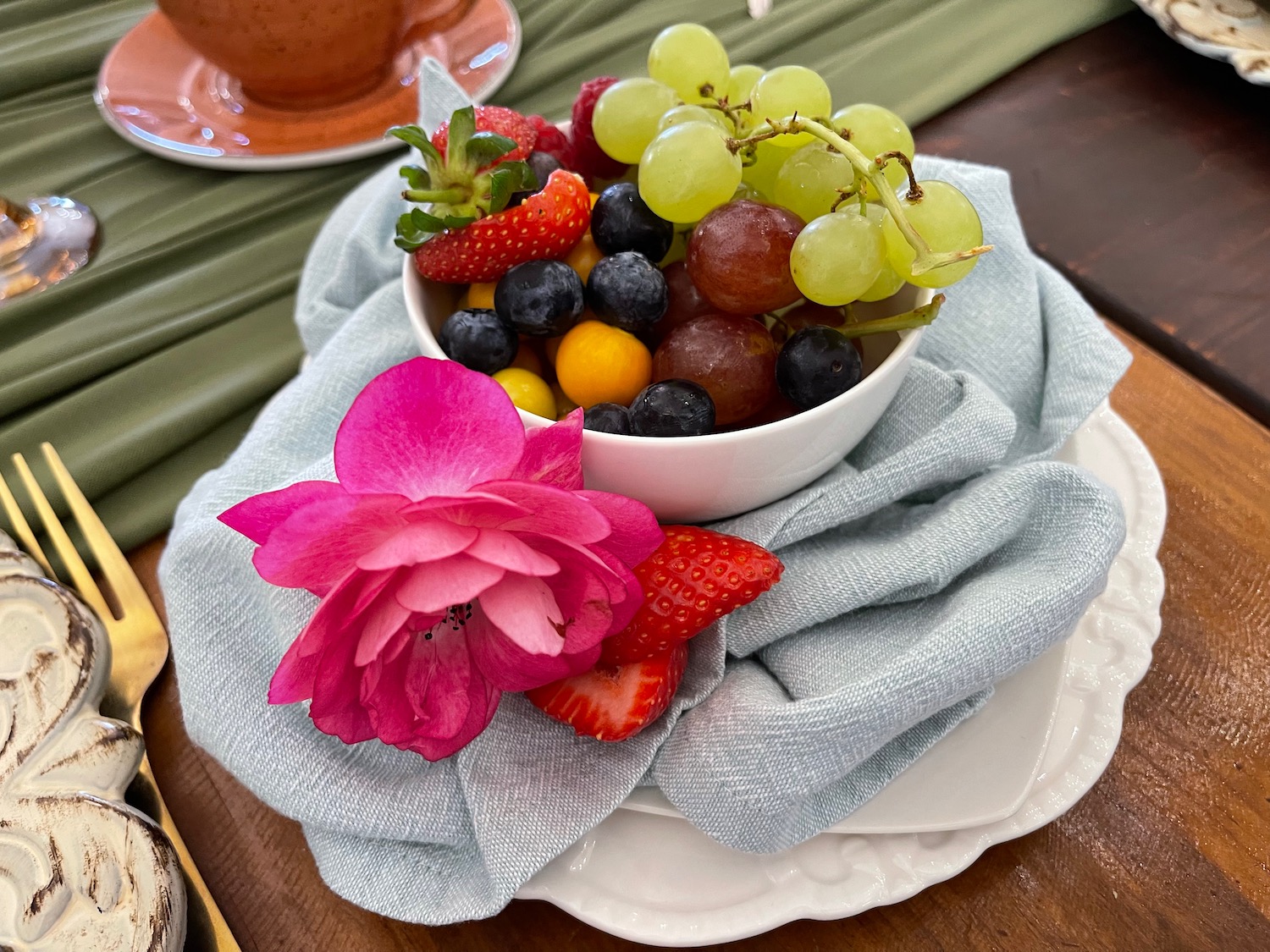 a bowl of fruit on a napkin