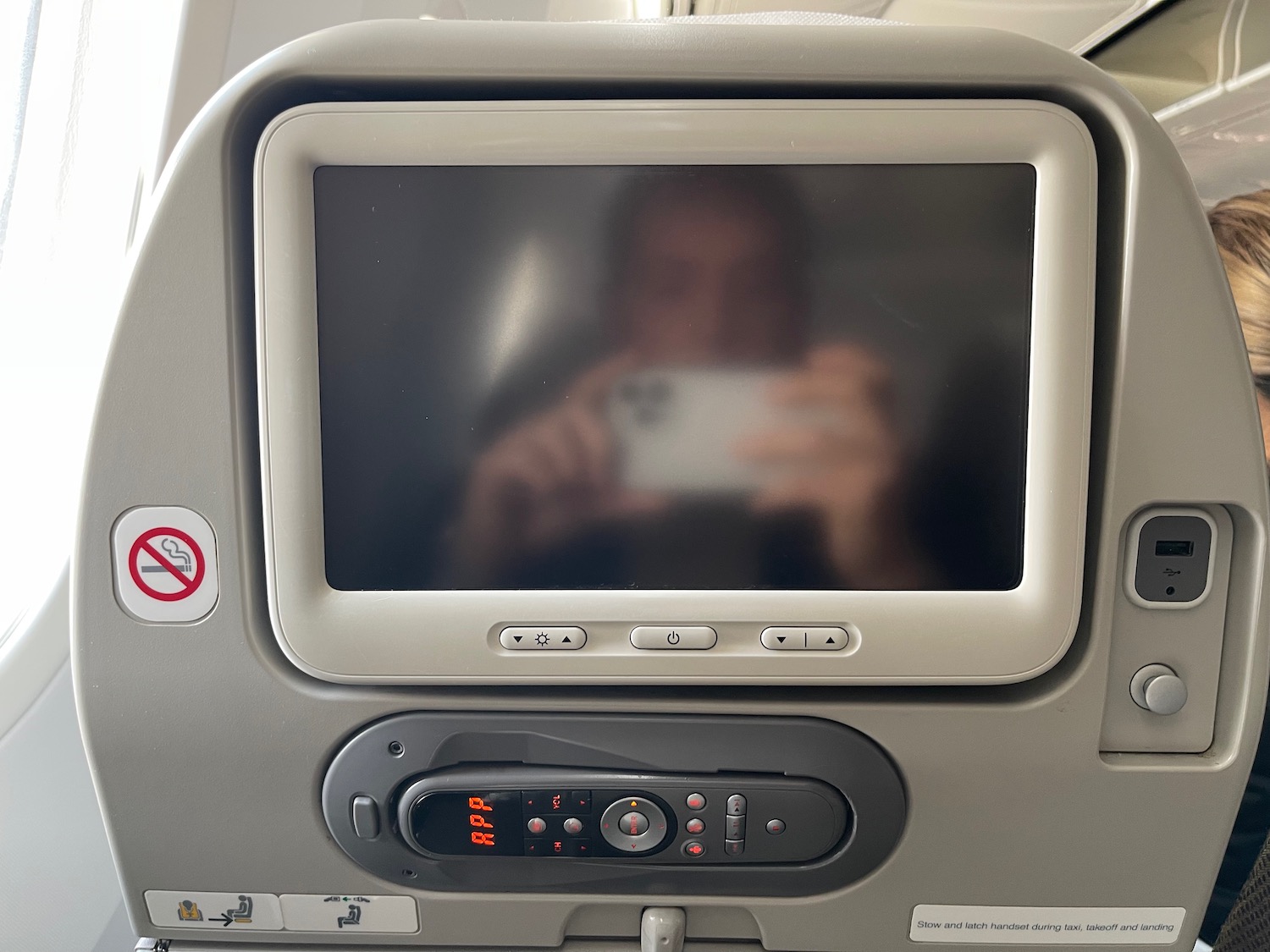 a person taking a selfie in an airplane