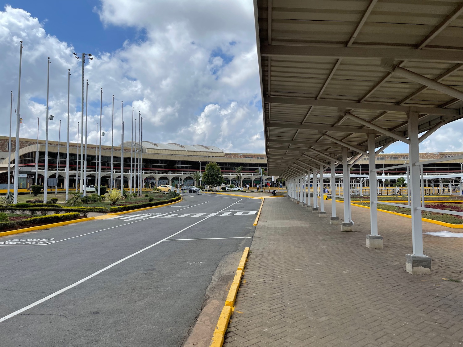 a road with a covered area and a building