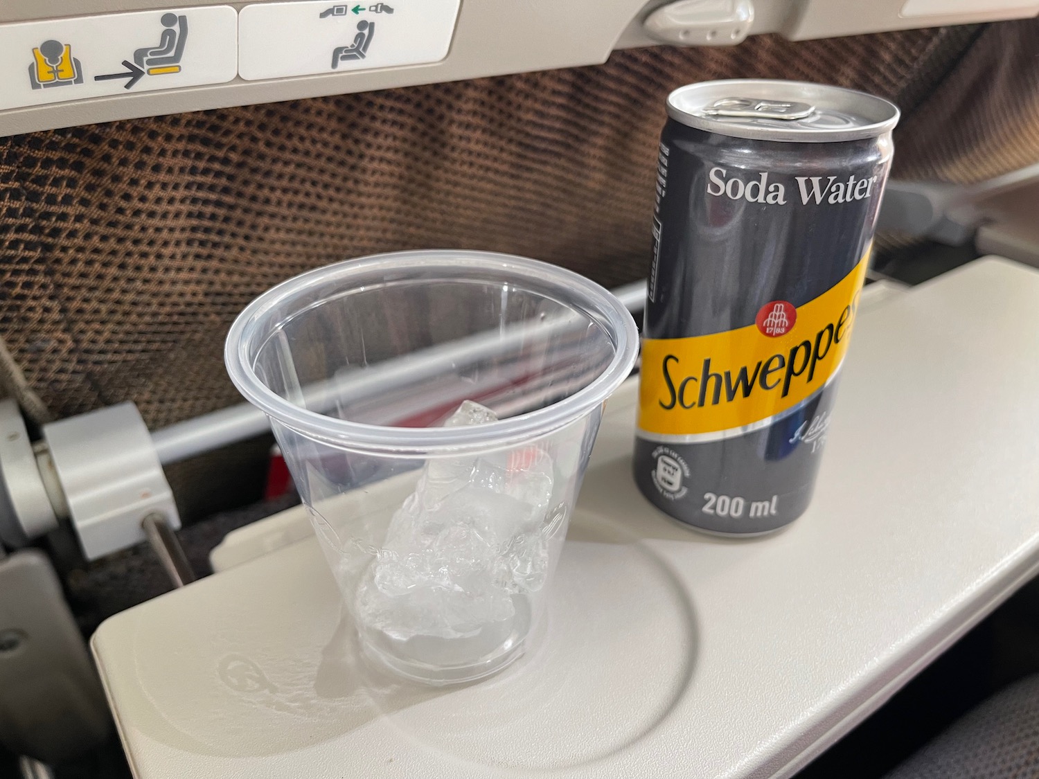 a plastic cup and a can of soda