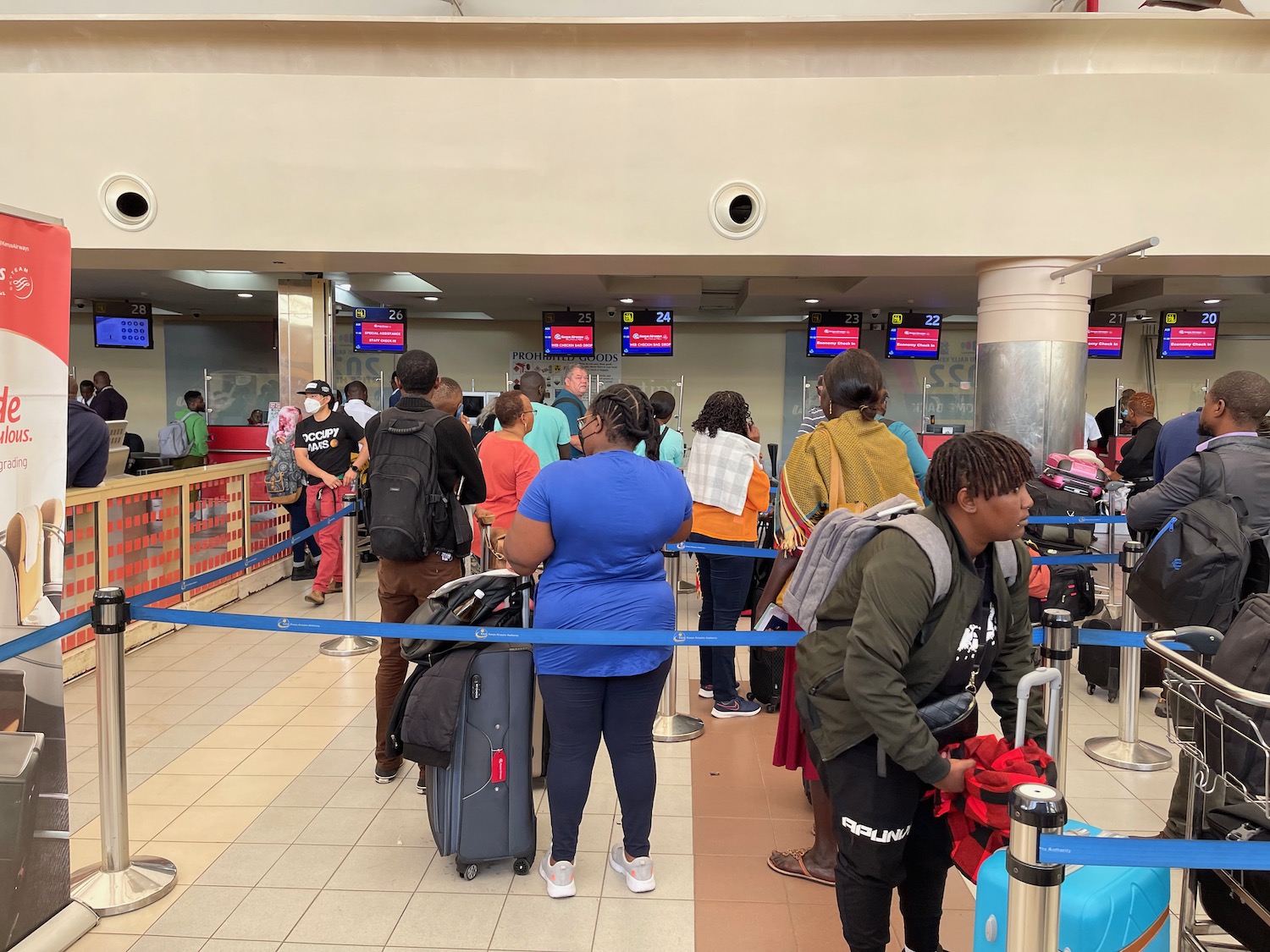 a group of people standing in line at an airport