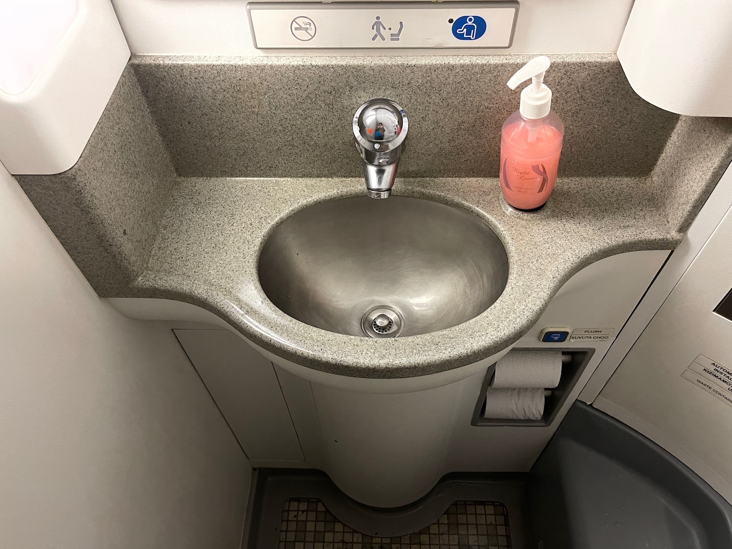 a sink with a soap bottle on the counter