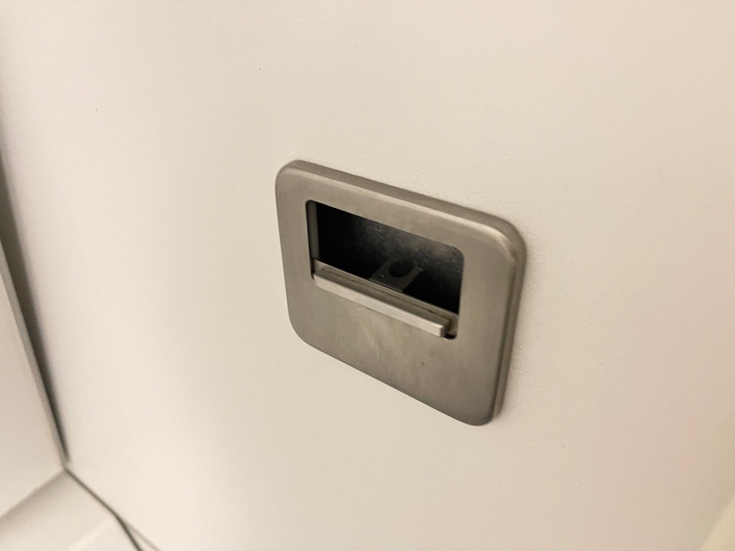 a metal square with a hole in the wall