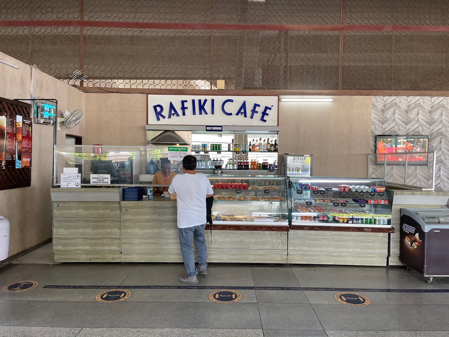 a man standing at a counter in a building