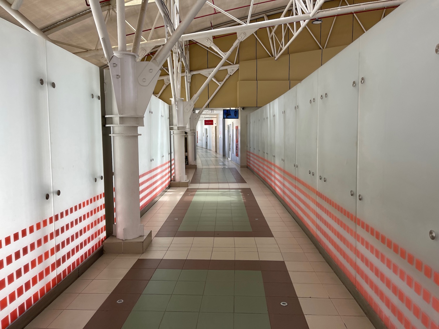 a hallway with white walls and red and white stripes