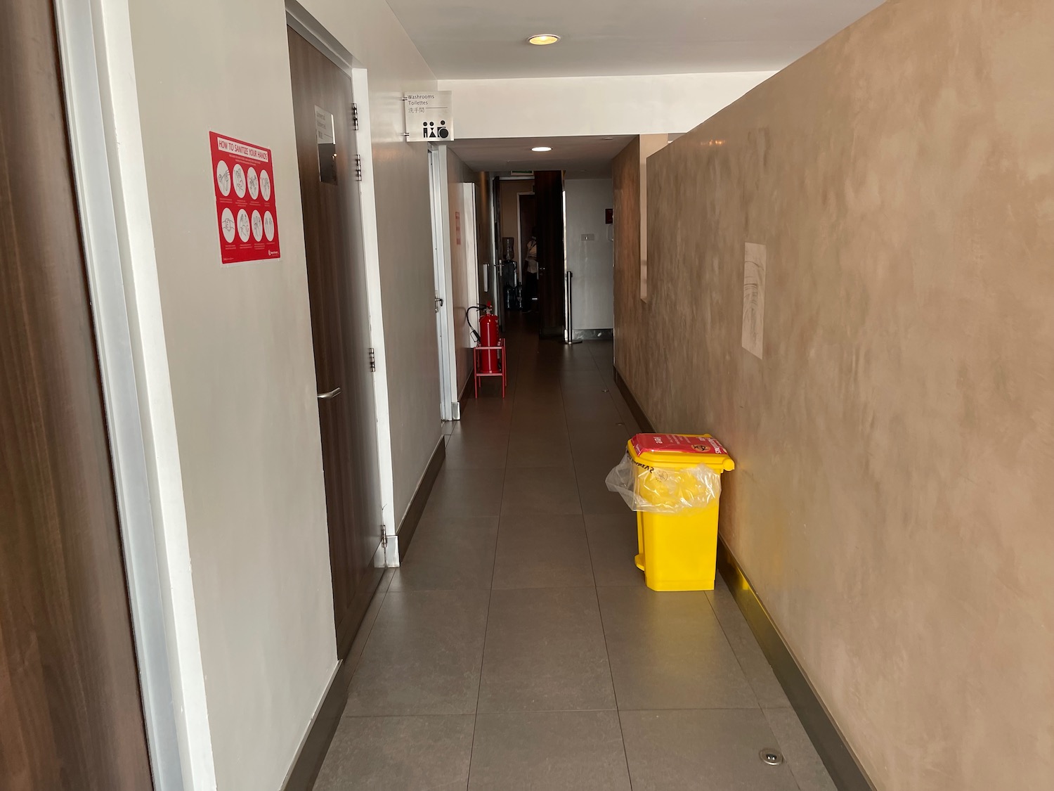 a hallway with a yellow trash can