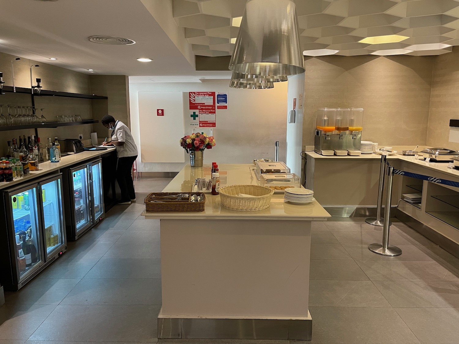 a kitchen with a counter and a man standing in the background