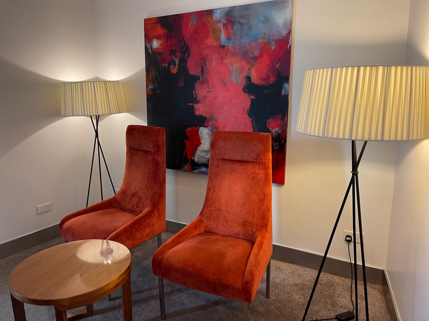 a red chairs and a painting on the wall