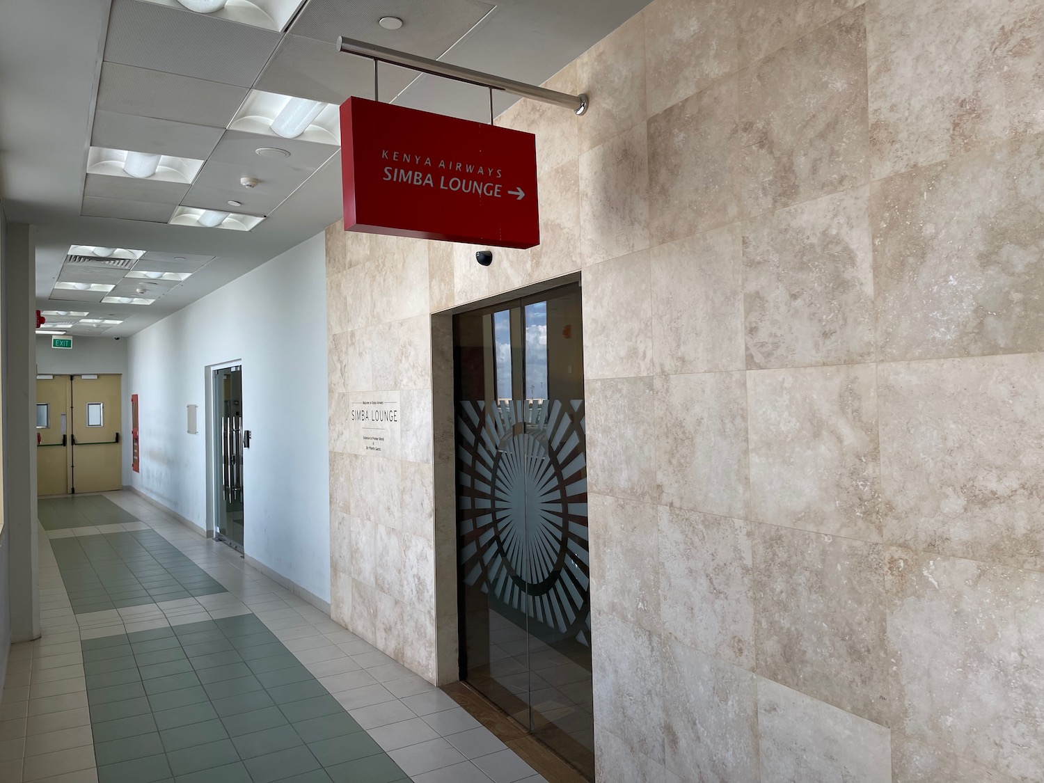 a hallway with a sign and a door