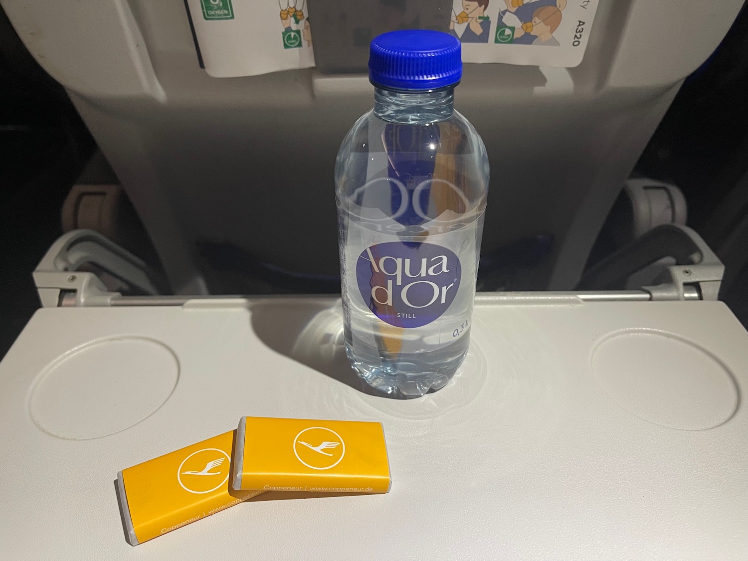 a bottle of water and two yellow bars on a plane