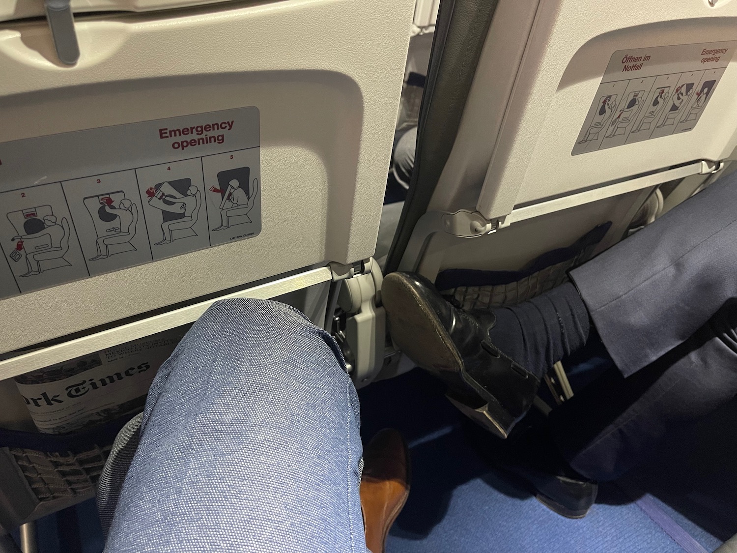 a person's legs and feet in an airplane