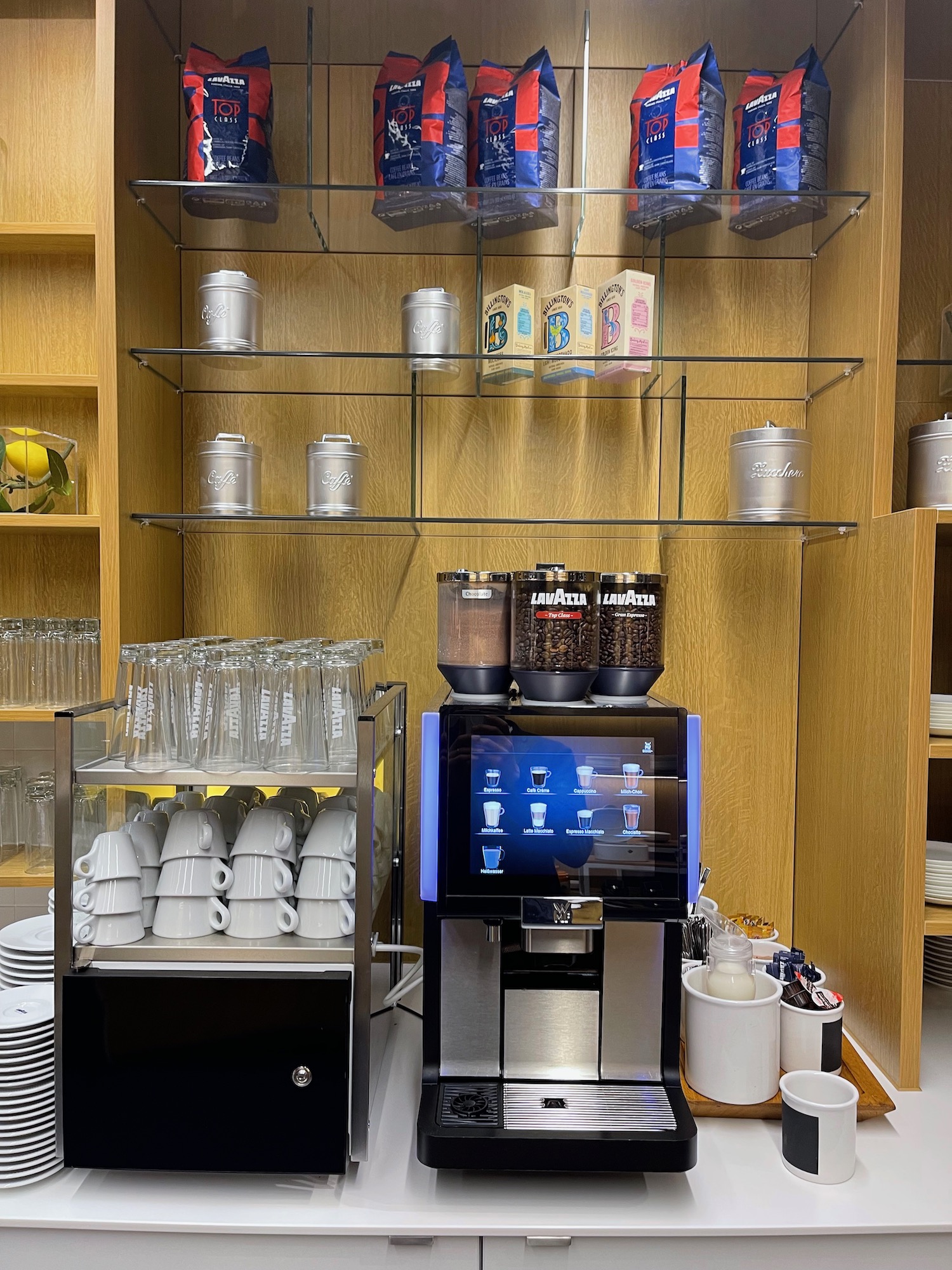 a coffee machine with a variety of coffee cups and mugs