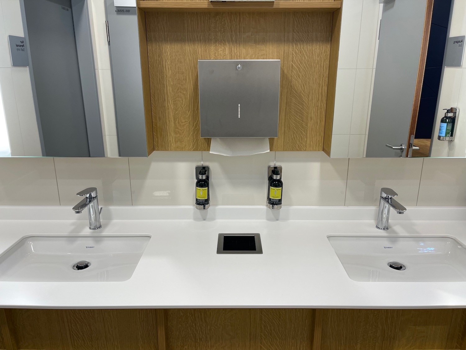 a bathroom sink with soap dispensers