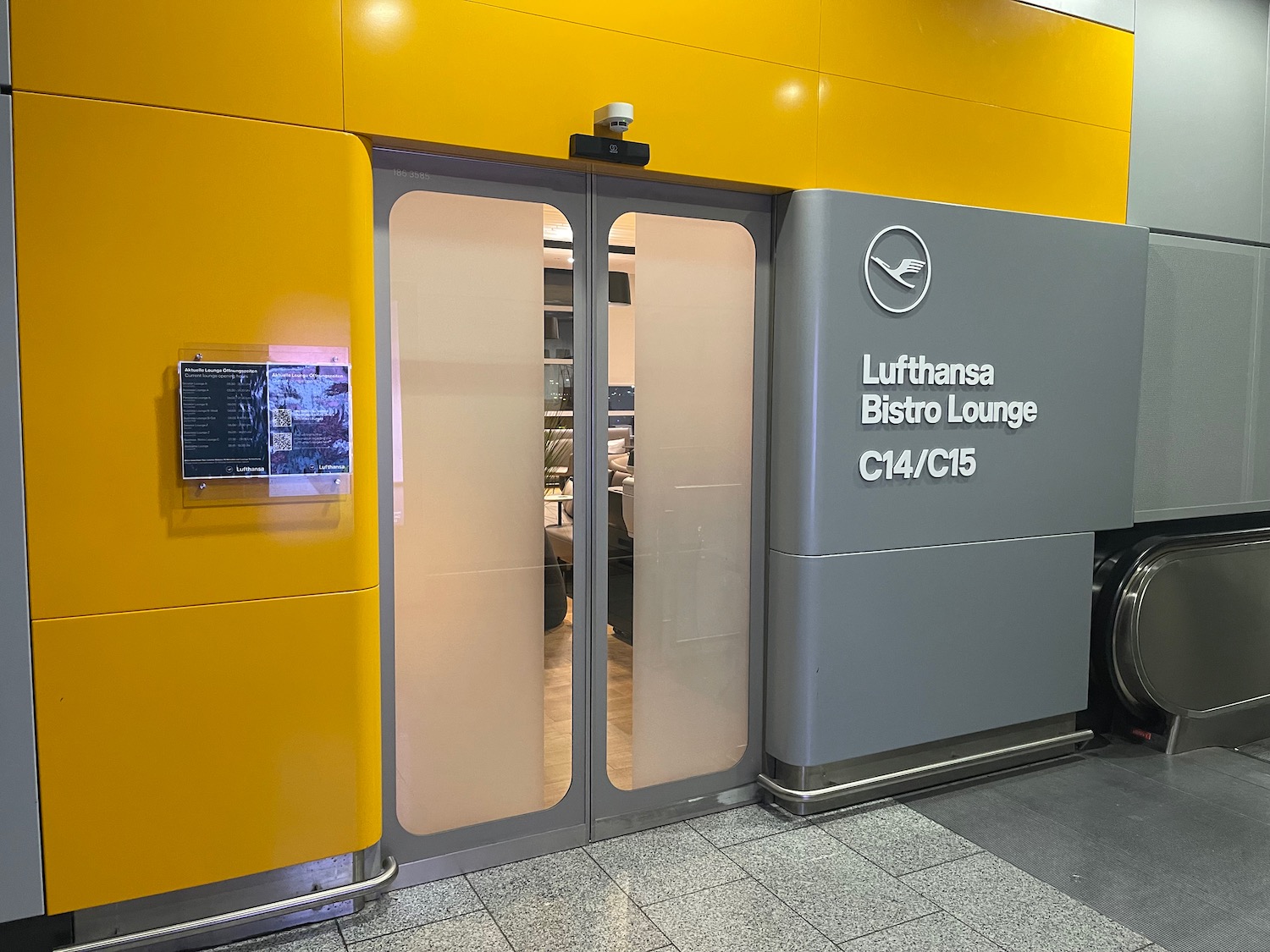 a yellow and grey building with glass doors