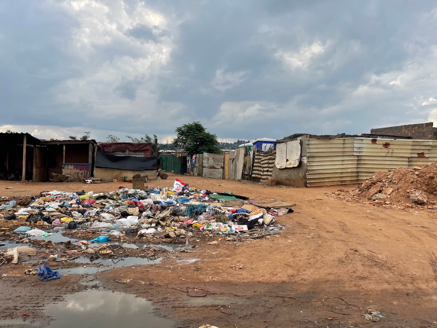 a pile of garbage in a muddy area