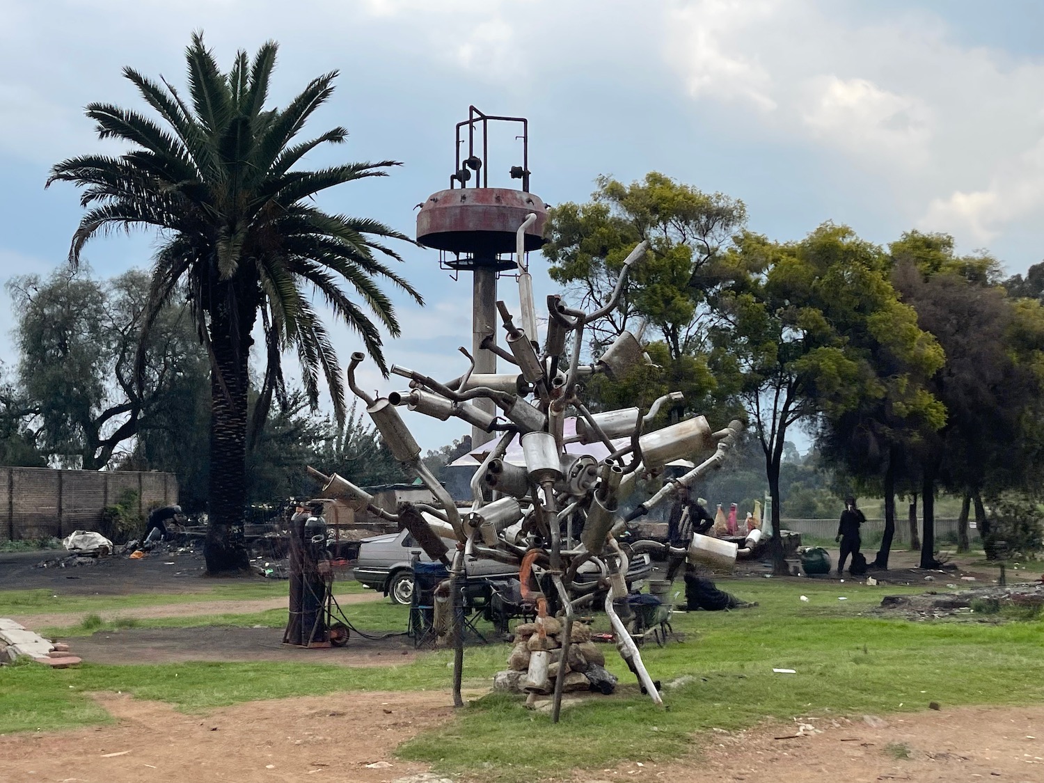 a sculpture made of mufflers and other objects