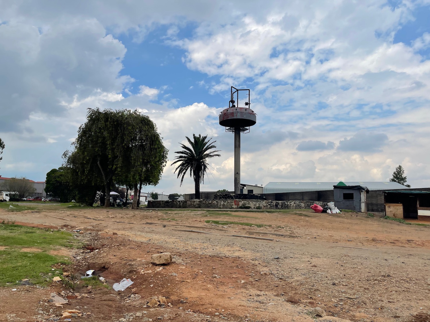 a water tower in a dirt field