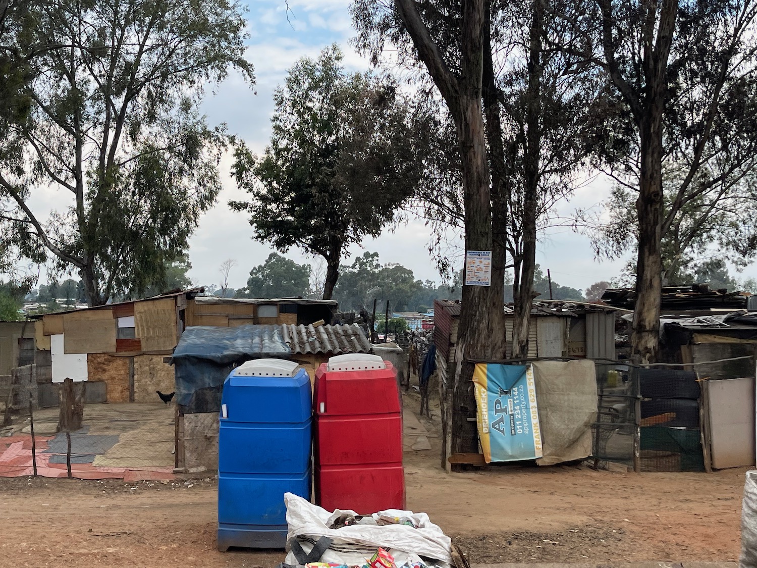 a group of plastic containers in a street