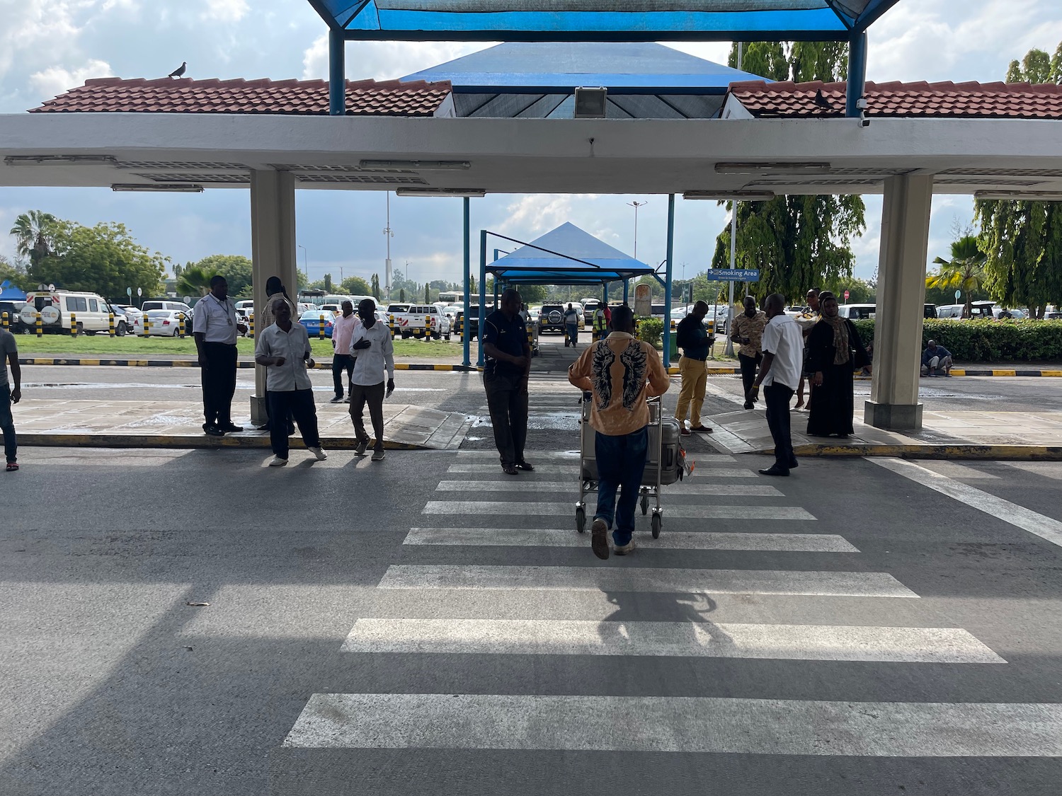 a group of people standing in a parking lot