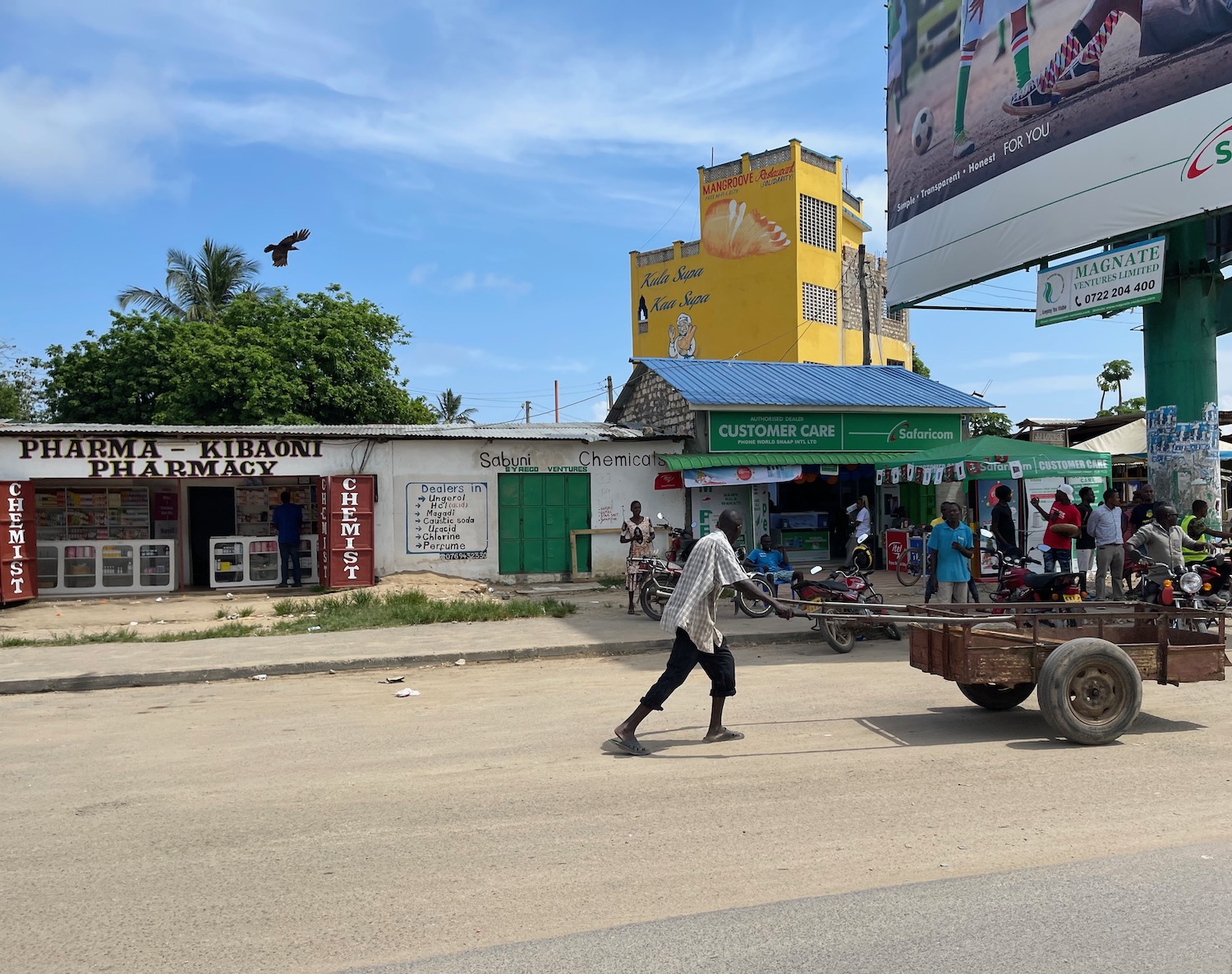 a man pushing a cart on a street