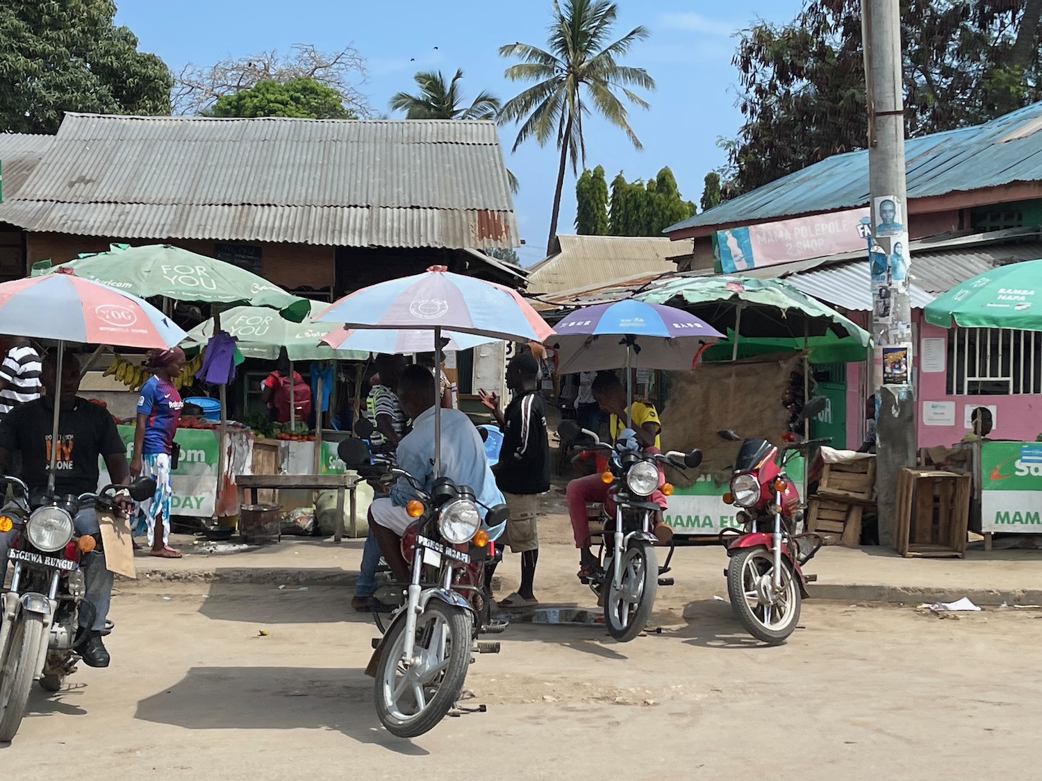 a group of people with motorcycles and umbrellas