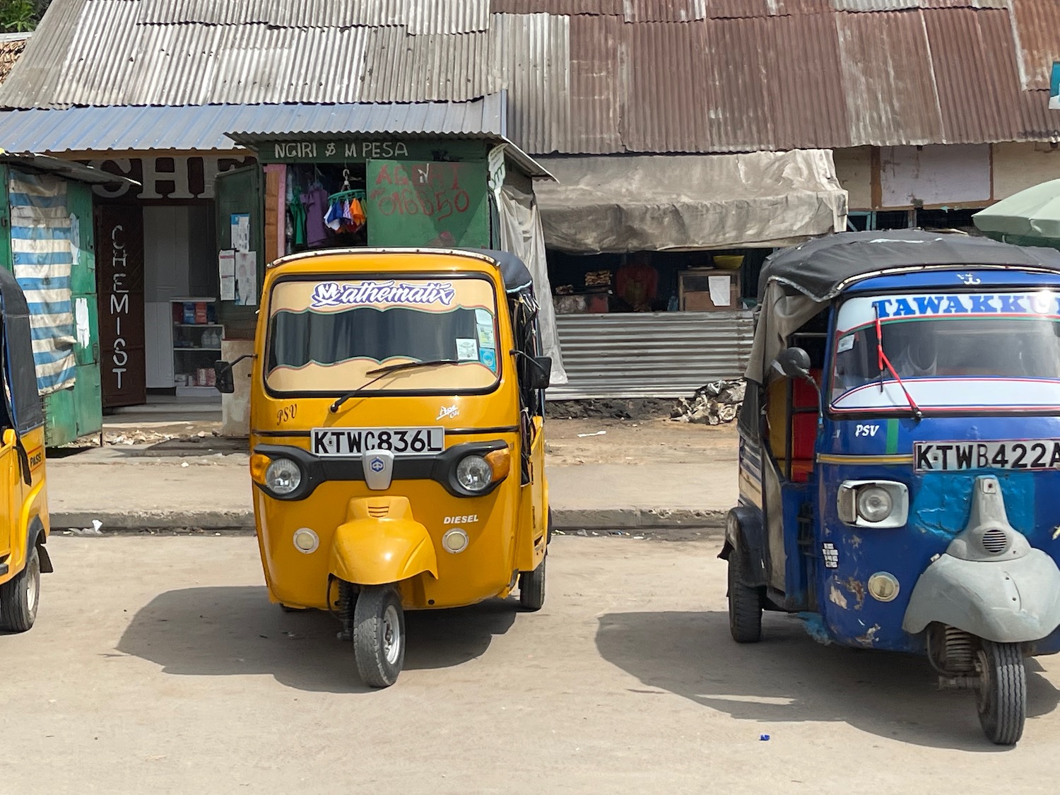 a two small cars parked in front of a building