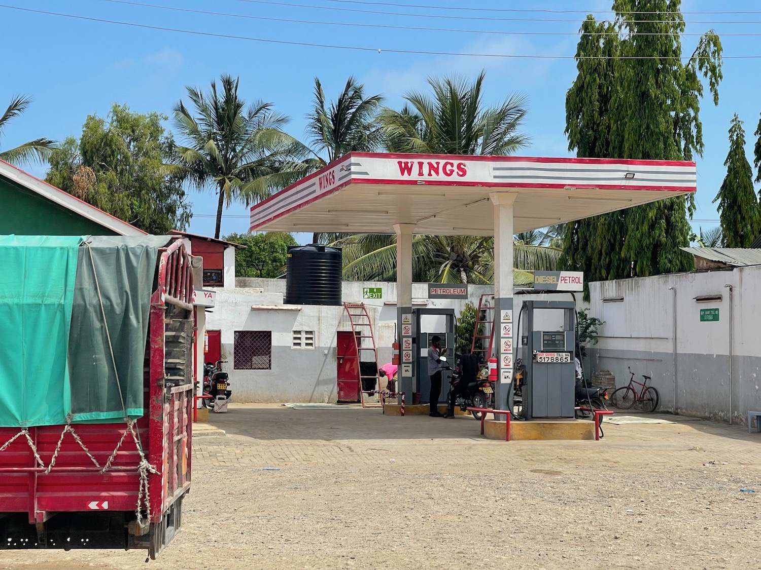 a gas station with a red and white canopy
