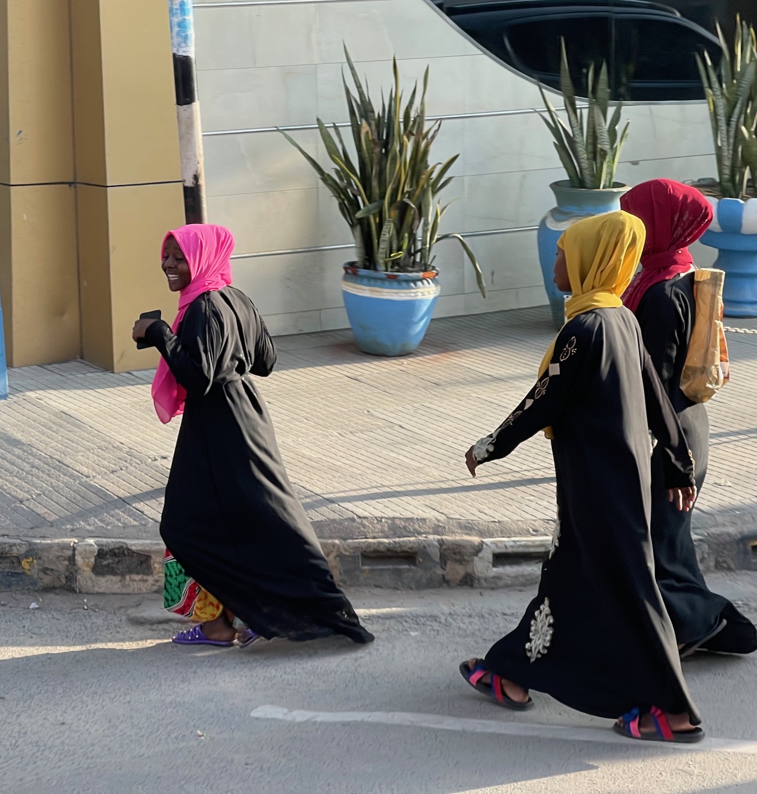 a group of women walking on a street