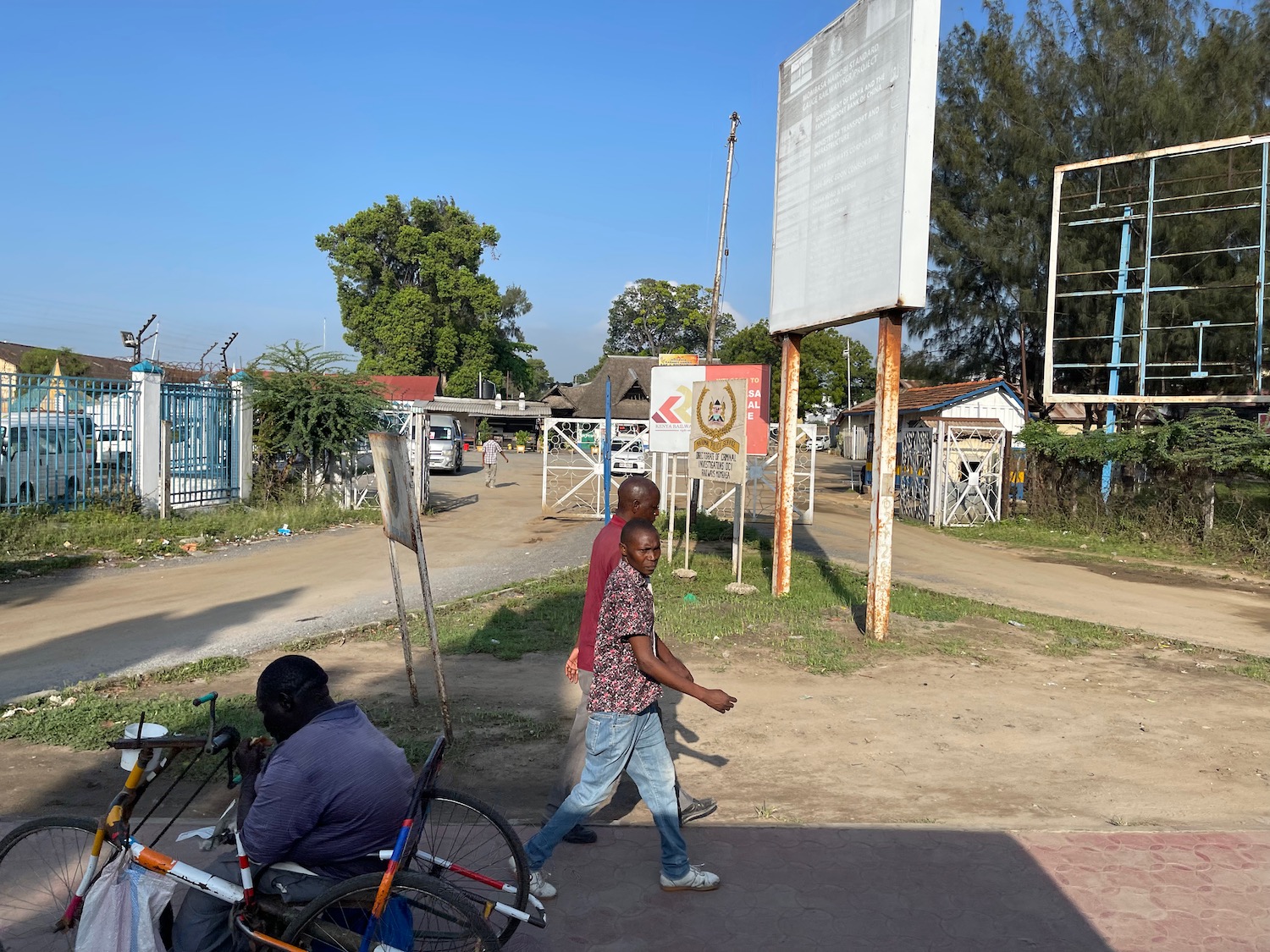 a man walking on a sidewalk with a man on a bicycle