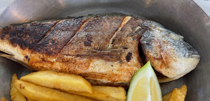 a fish and fries in a pan