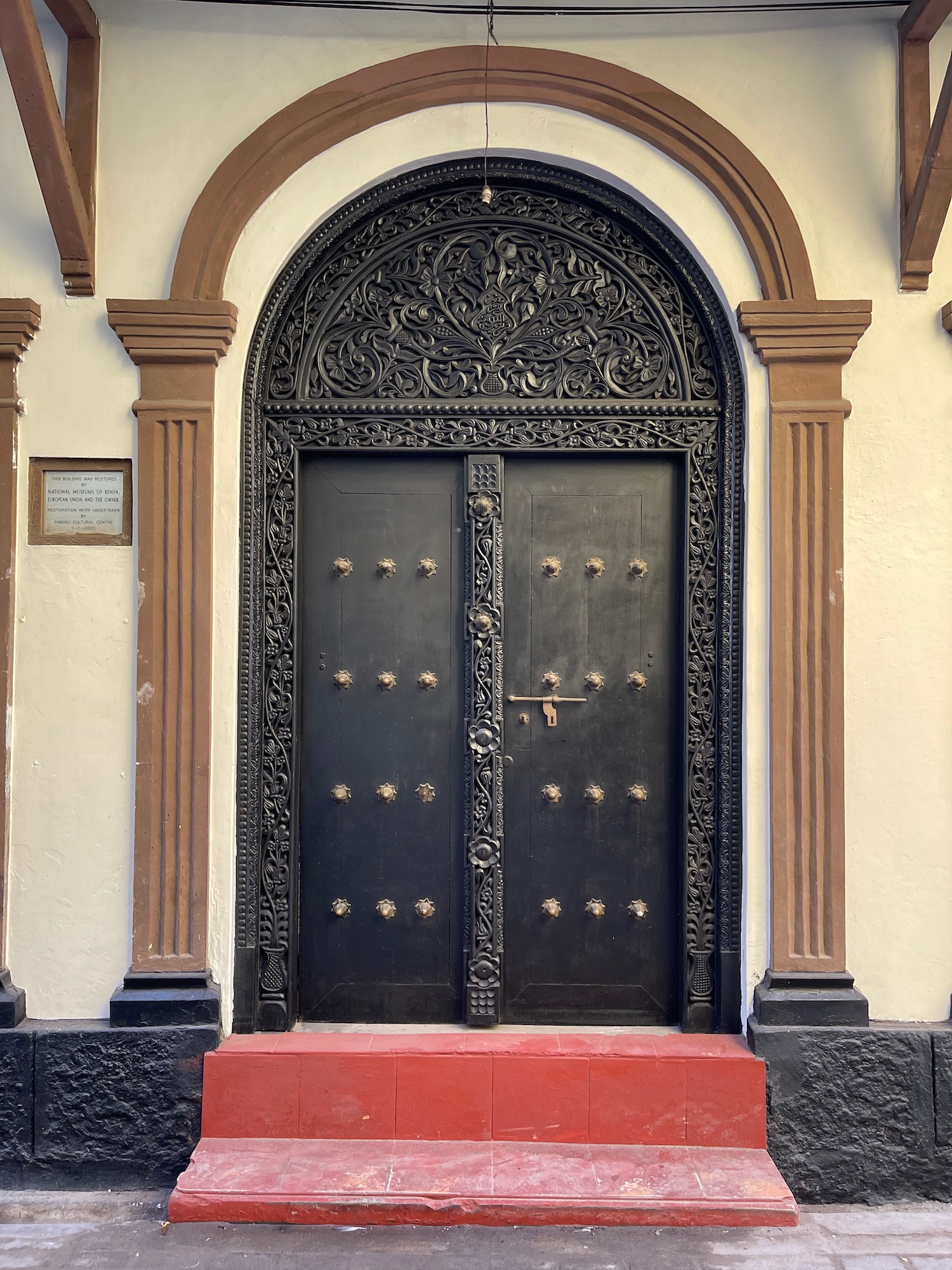 a black door with gold trim