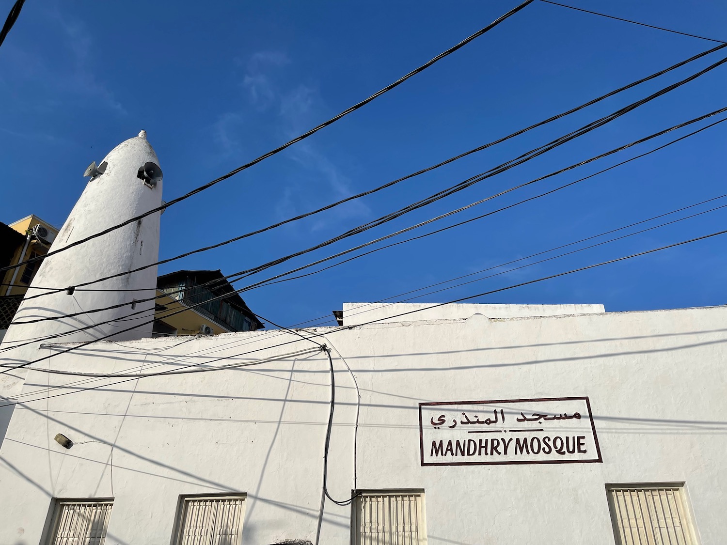 a building with a tower and a sign on the side