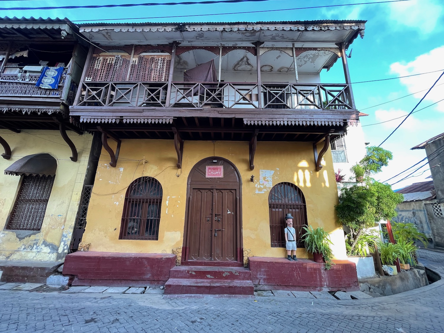 a person standing in front of a yellow building