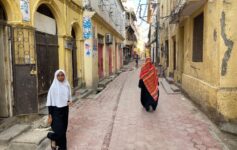 two women walking down a street