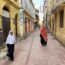 two women walking down a street