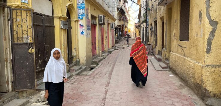 two women walking down a street