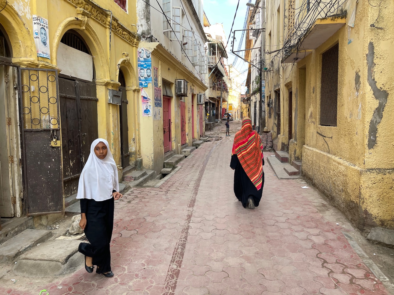 two women walking down a street