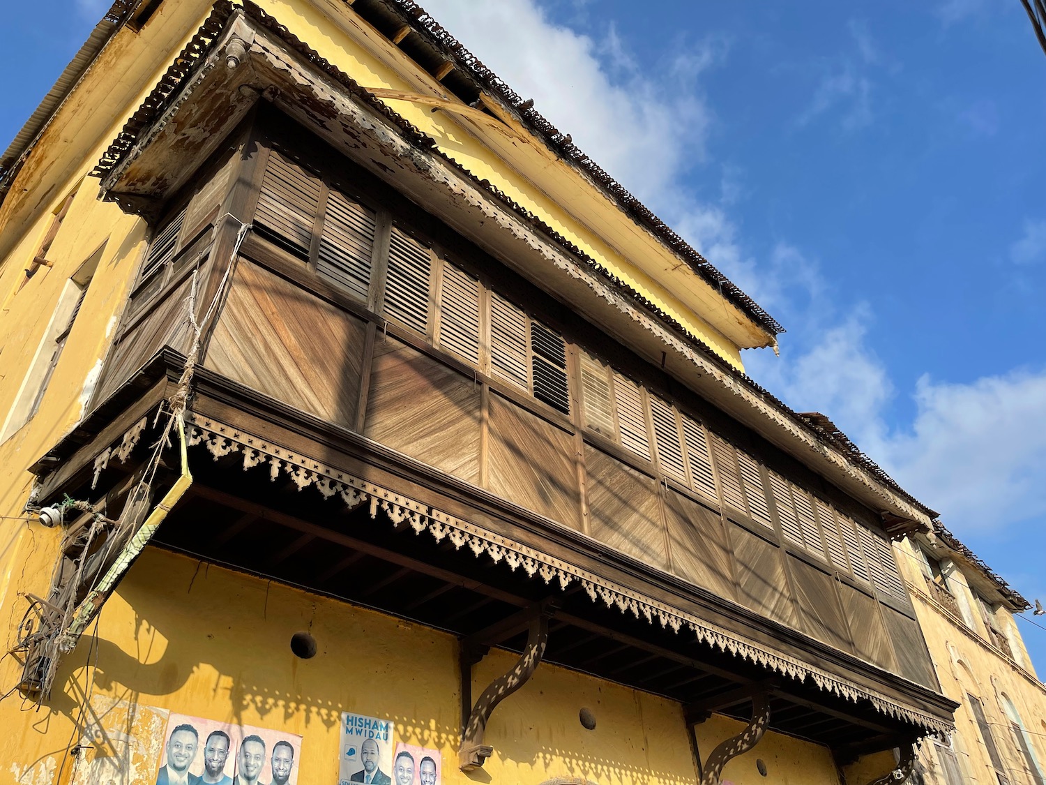 a yellow building with a balcony