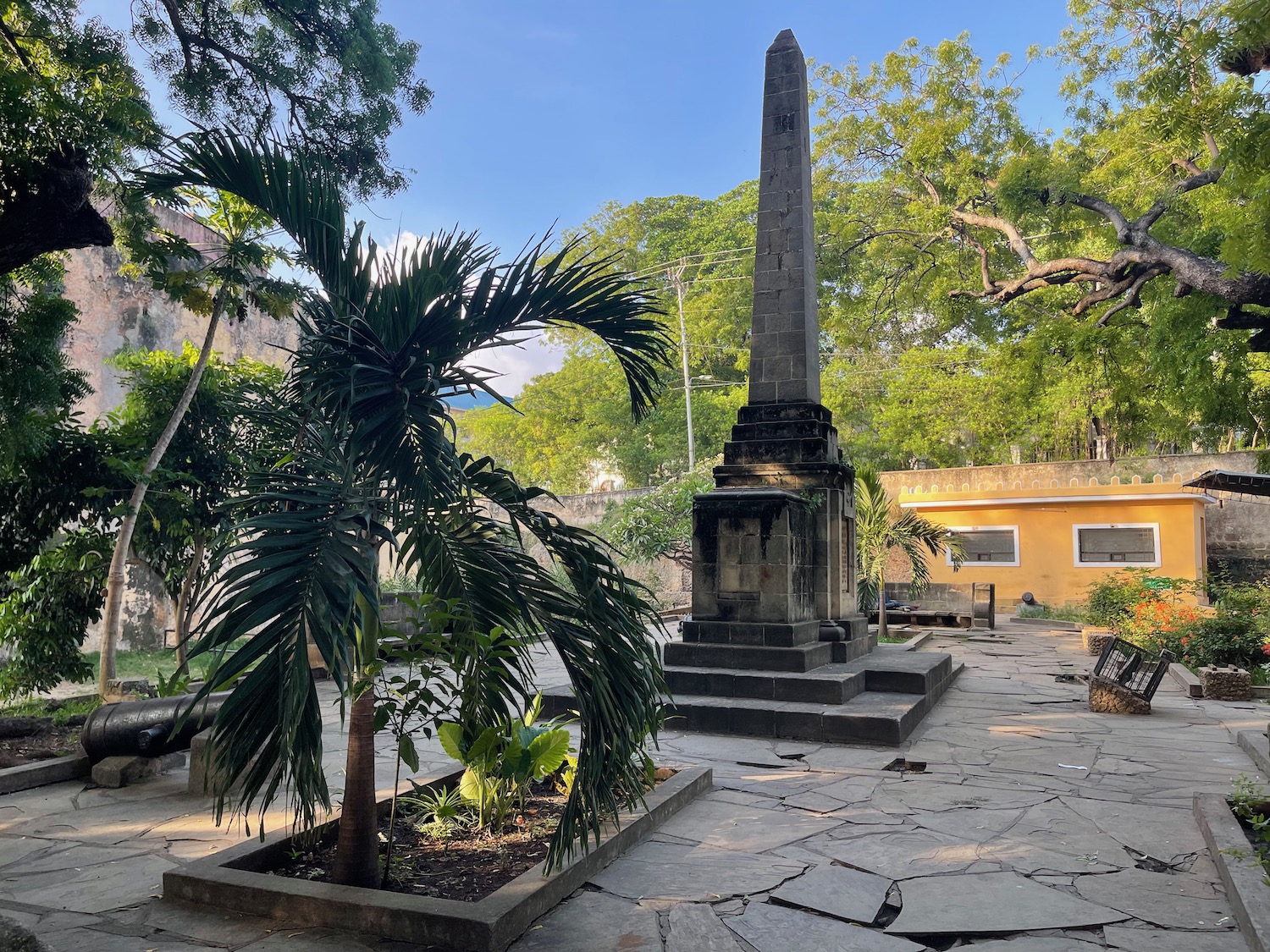 a stone obelisk in a courtyard