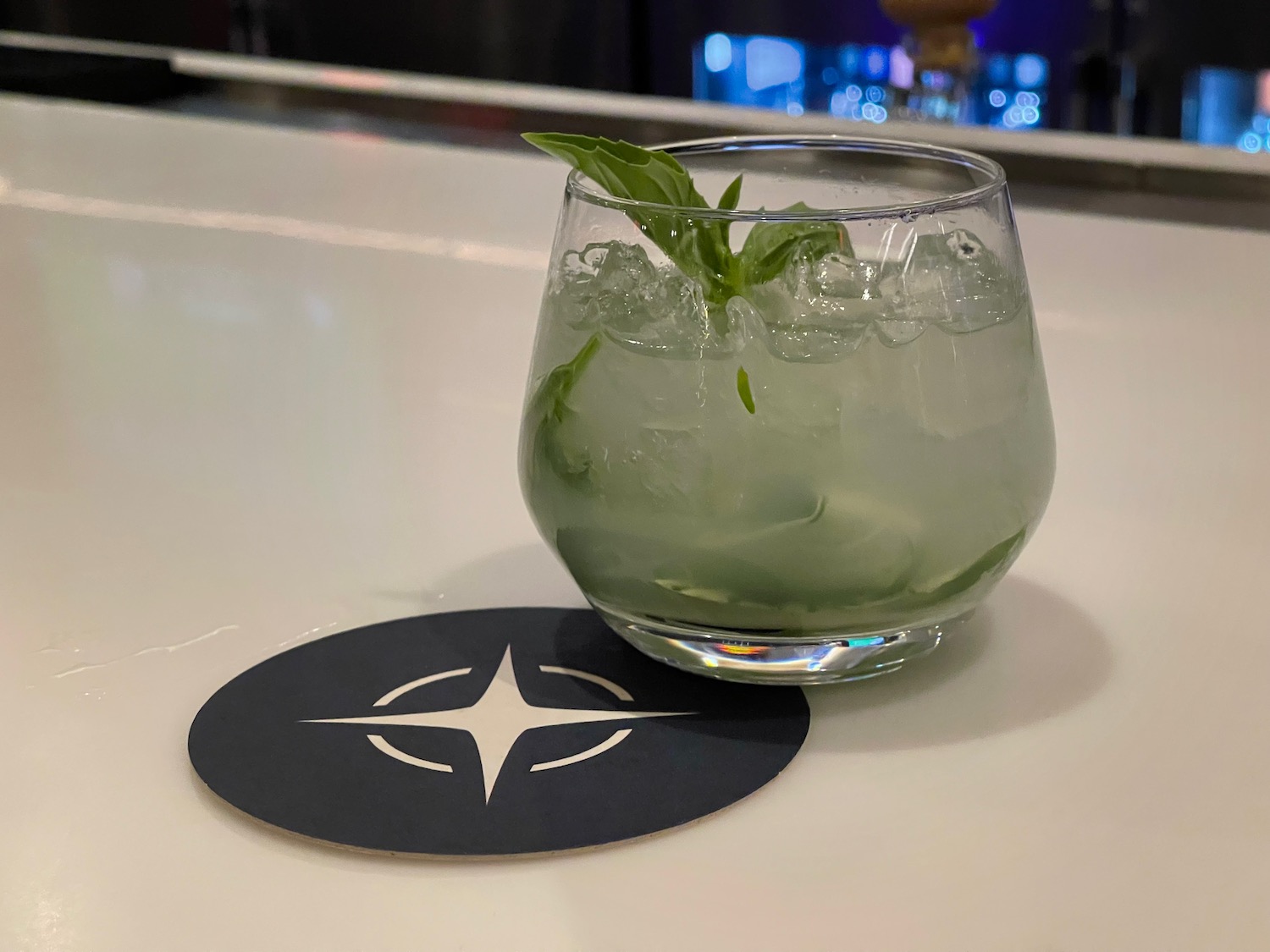a glass with a drink and a leaf on it