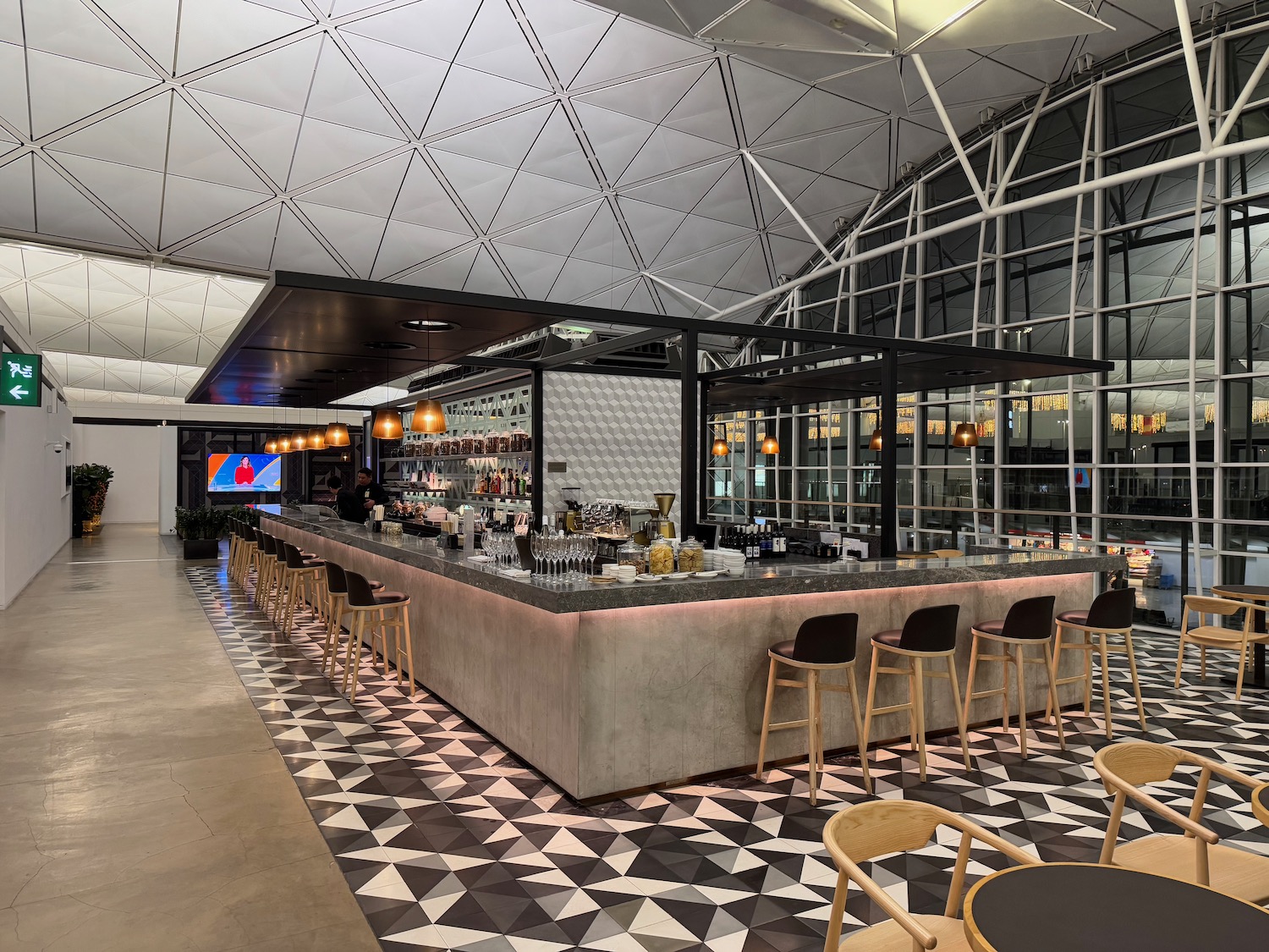 a bar with a counter and chairs in a building