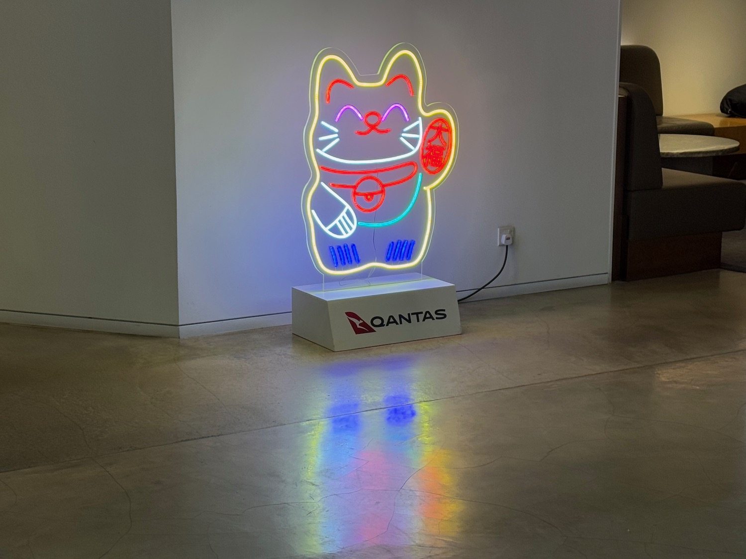 a neon cat on a stand