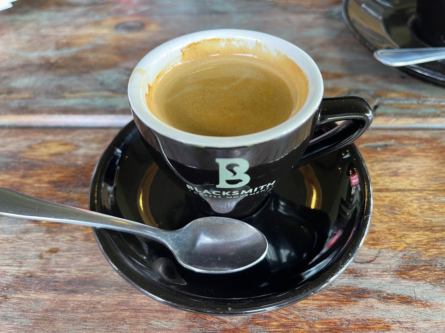 a cup of coffee with a spoon on a saucer