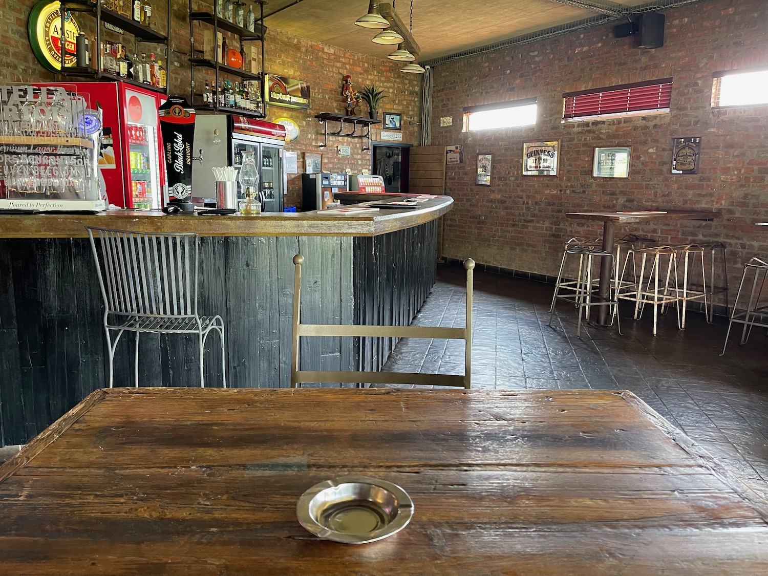 a bar with a wooden table and chairs