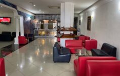 a room with red and blue chairs and a white tile floor