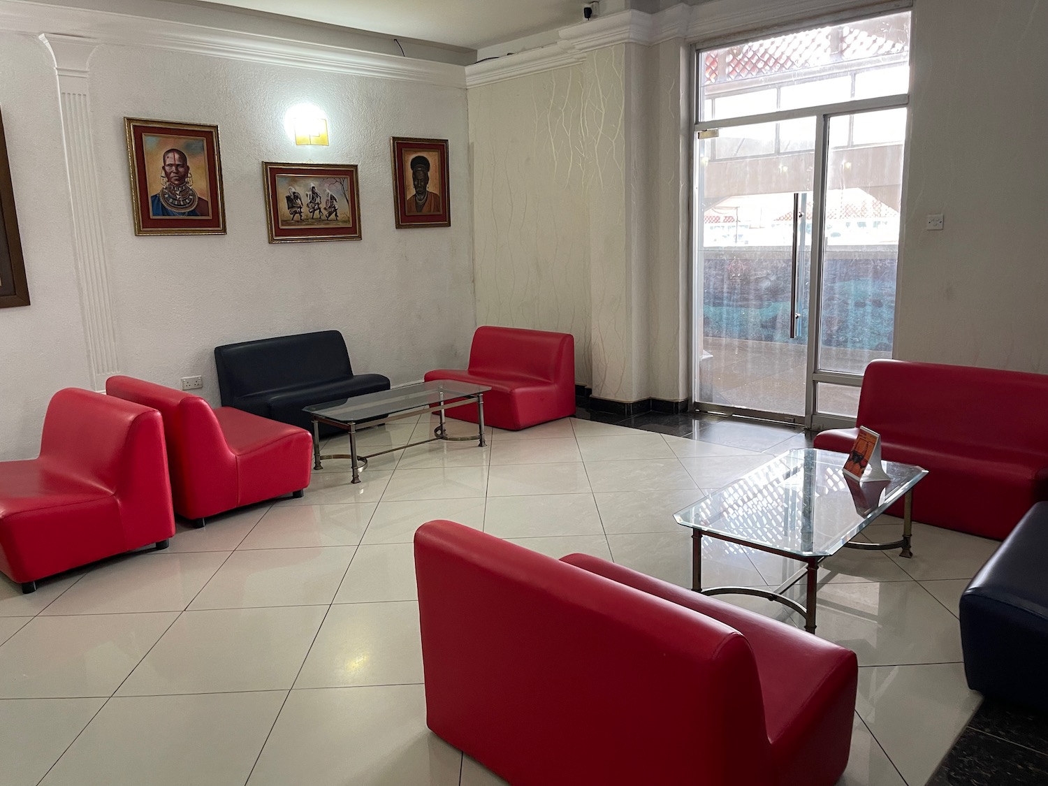 a room with red couches and a glass table