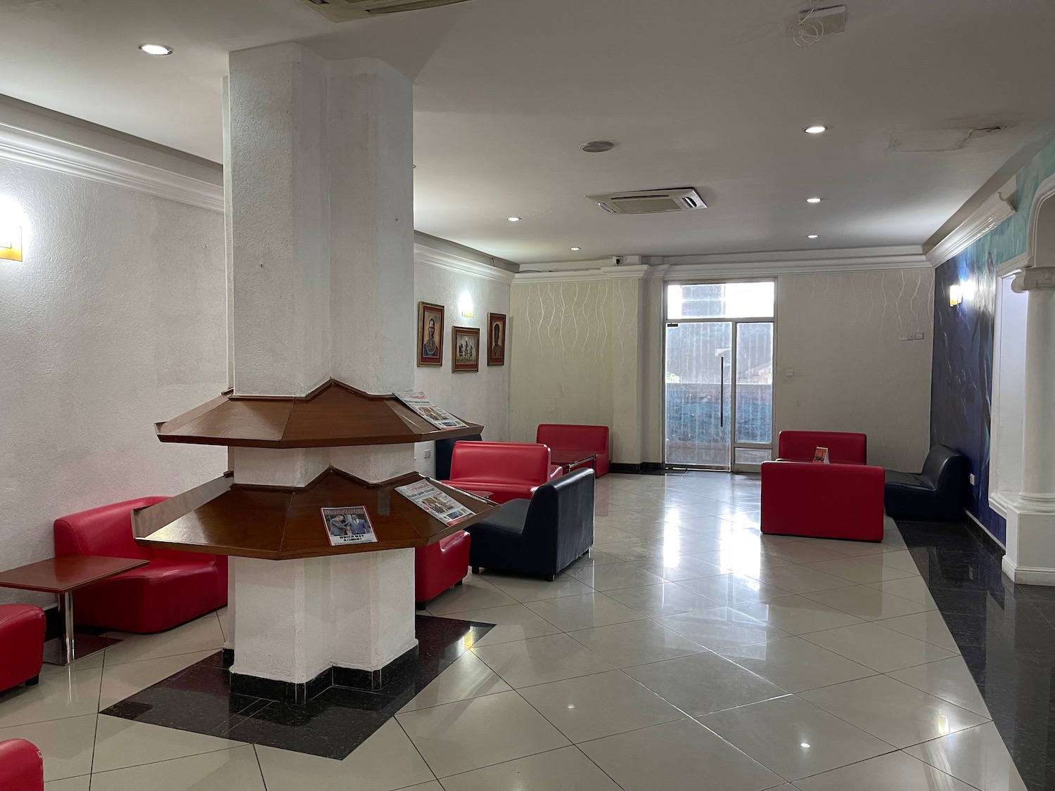 a room with red couches and a white column