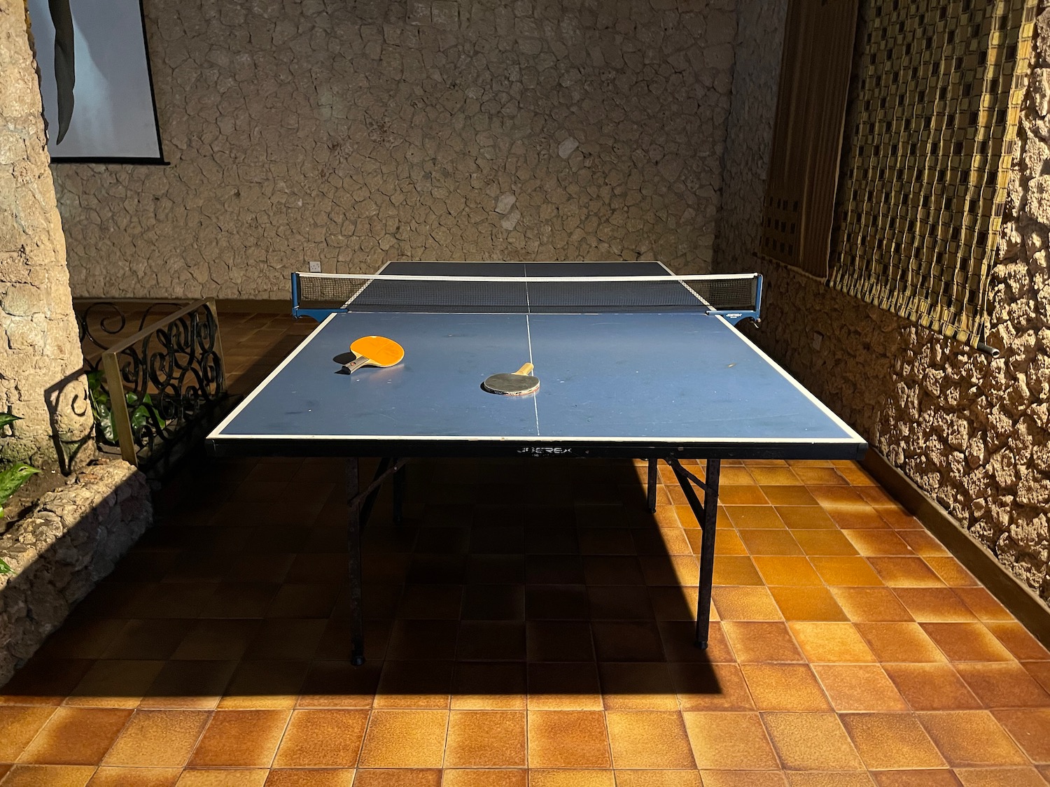 a ping pong table with rackets and a net