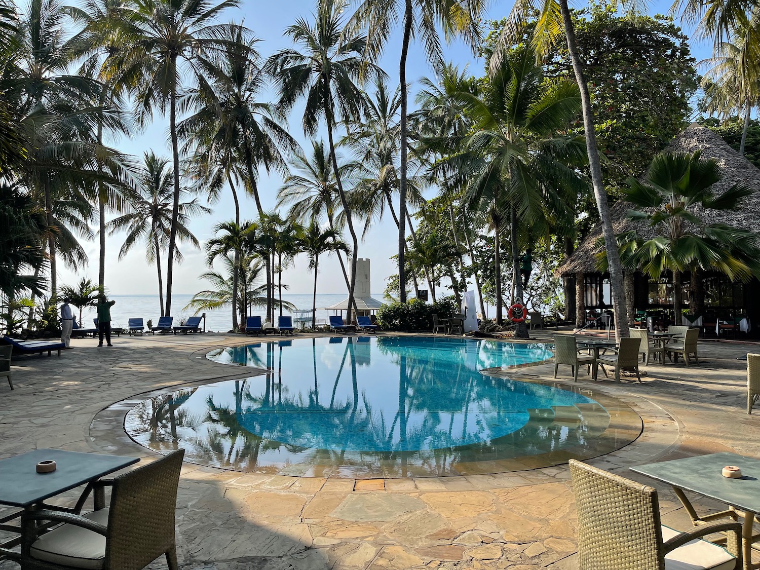 a pool with chairs and chairs around it