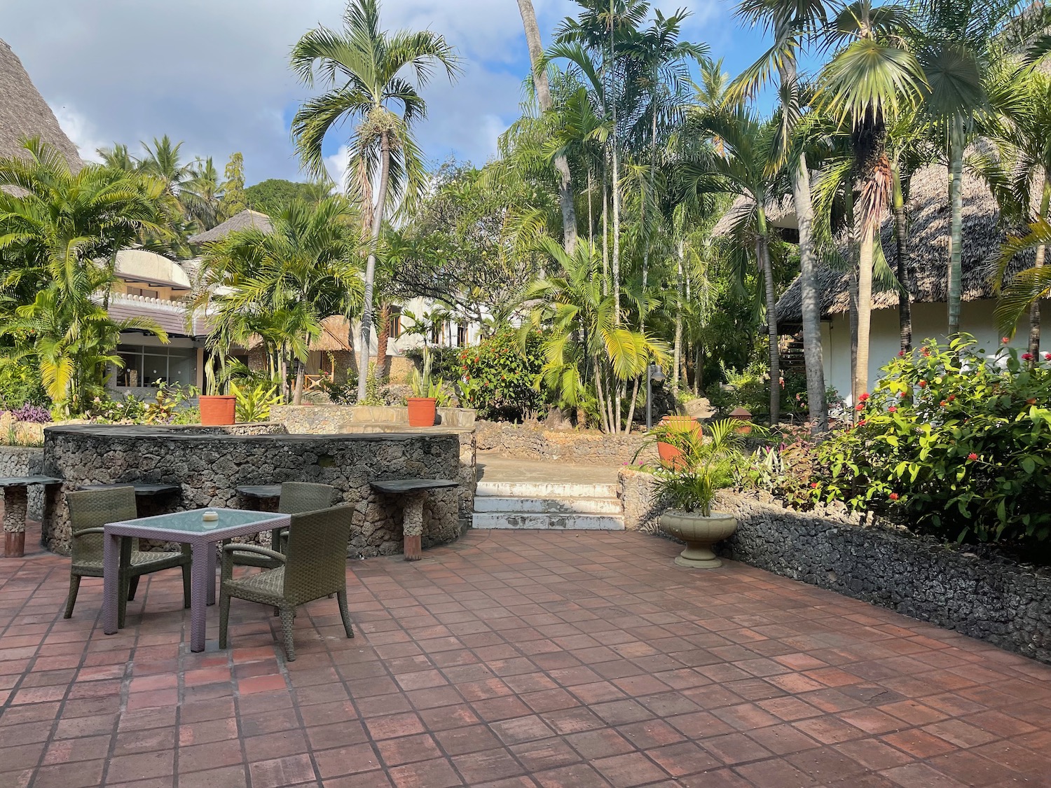 a patio with chairs and trees